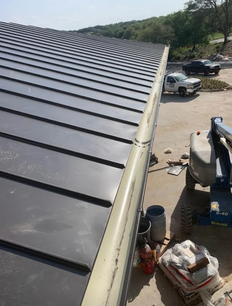 Standing seam panel and gutter detail on a metal roofing jobsite in Beacon